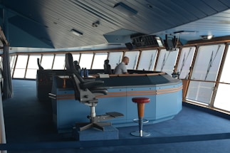man standing inside boat