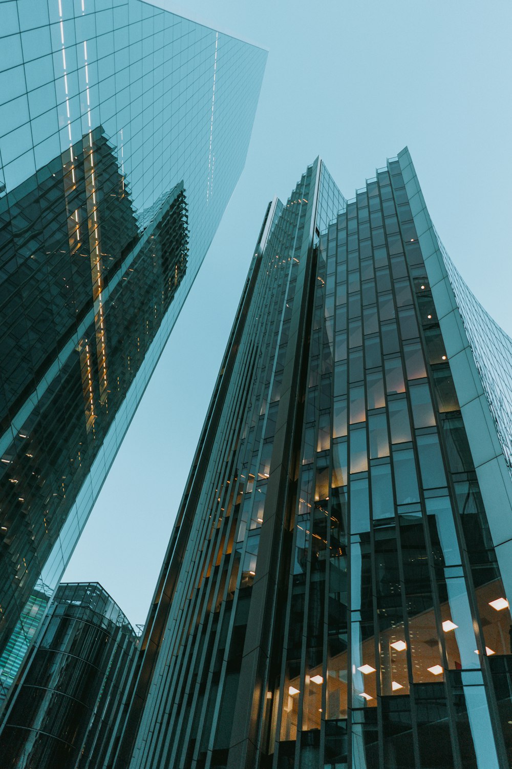 low-angle photography of blue glass walled high-rise buildings