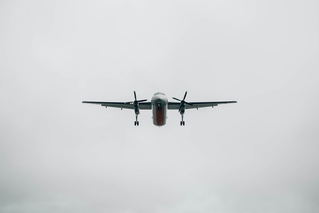 flying grey plane during daytime