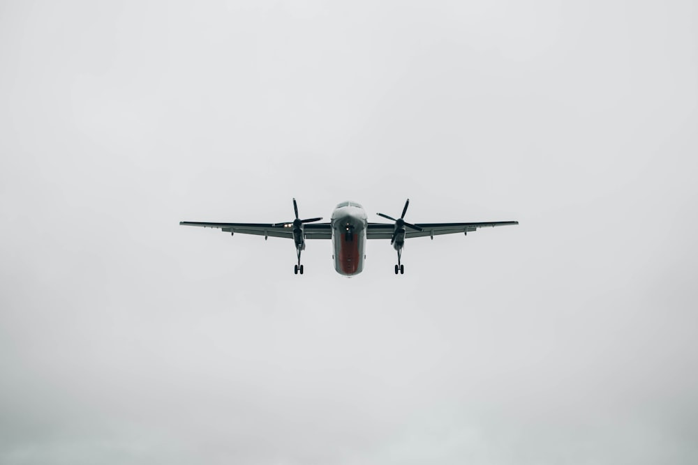 flying grey plane during daytime