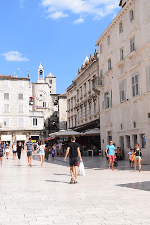 Historic European plaza with charming cafes and people enjoying the afternoon.