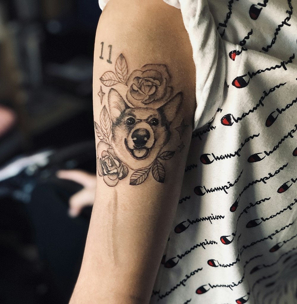 wolf with roses arm tattoo