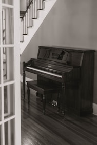 console piano under stairs