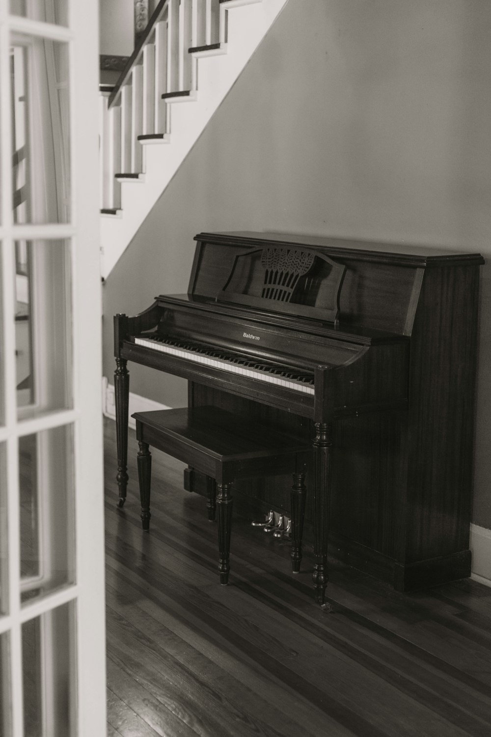 console piano under stairs