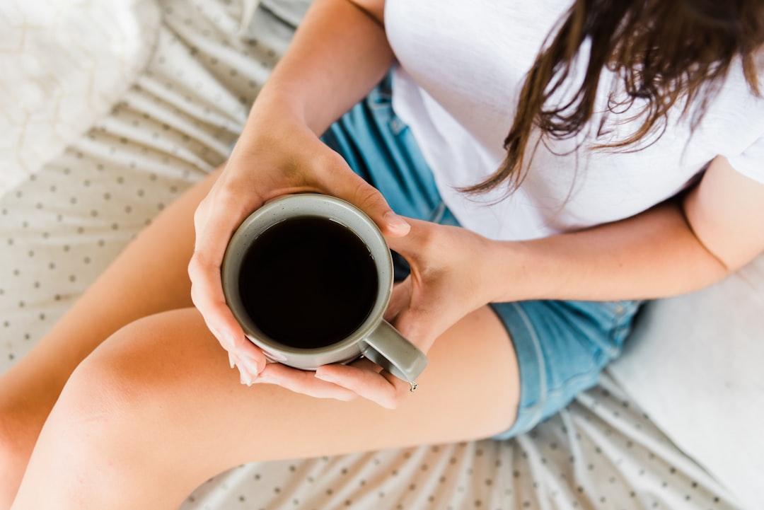 woman holding full ceramic mug