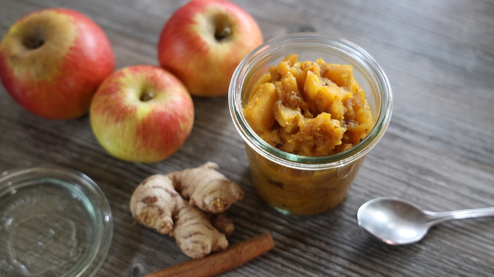 ginger near stainless steel spoon, three apple fruits, and cinnamon