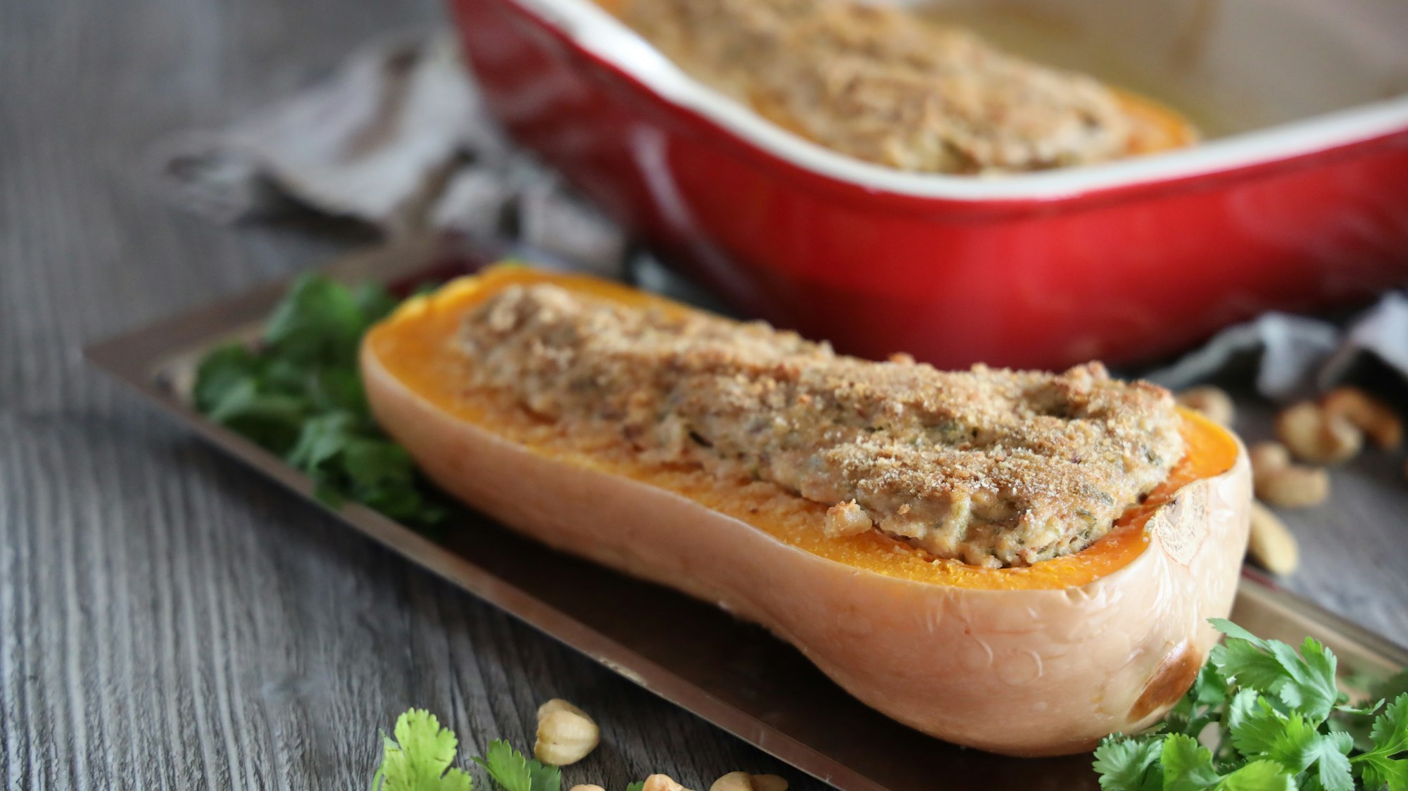 Baked stuffed butternut pumpkin with cashew coriander cream cheese, organic food, healthy food, vegan cooking, autumn dish, le creuset cherry red baking dish