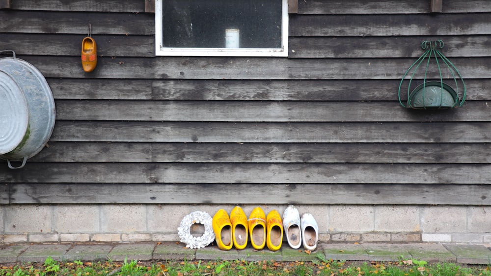 yellow and white flats leaning on wooden wall