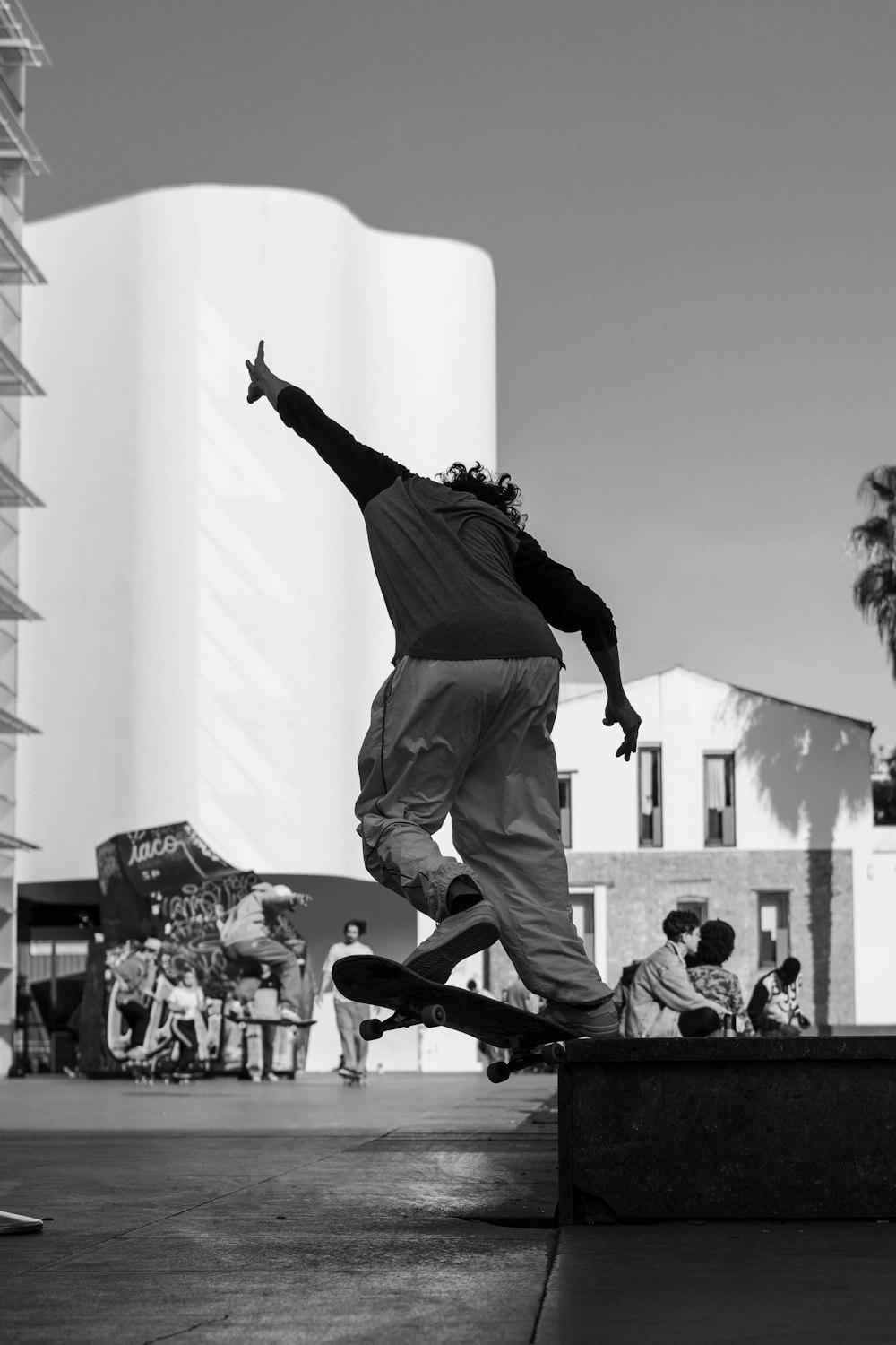 grayscale photography of person skateboarding on ramp