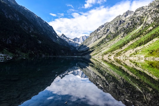 view photography of lake between mountain during daytime in Lac de Gaube France
