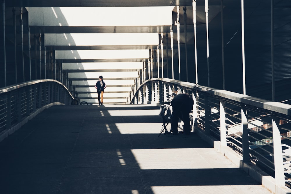 person walking in bridge during daytime