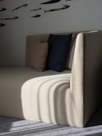 square white and black throw pillows on white fabric couch