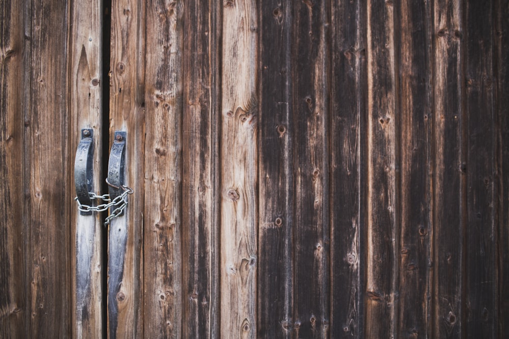 a wooden fence with a chain on it