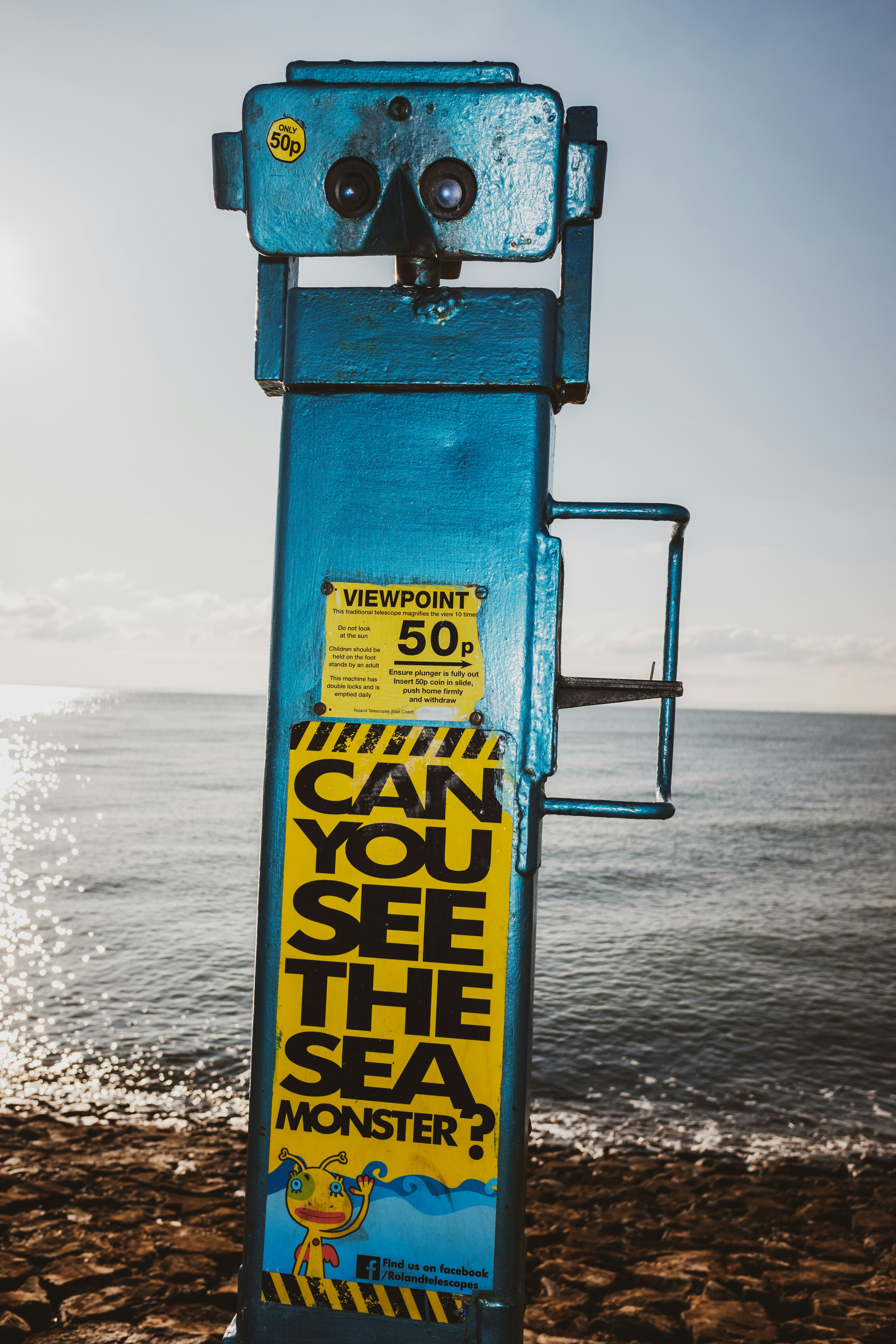 blue and yellow telescope on seashore
