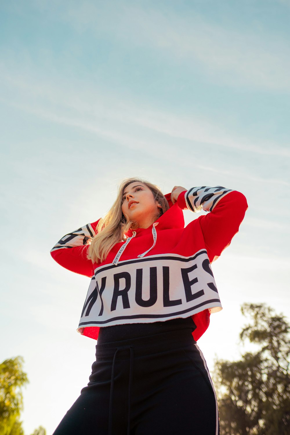 shallow focus photo of woman in red and white pullover hoodie