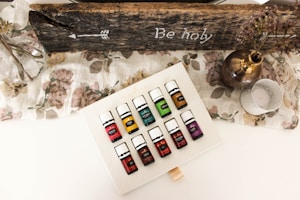A collection of colorful essential oil bottles arranged on a rustic table