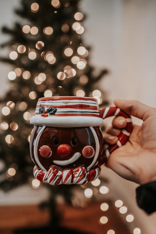 Close-up of a personalized mug featuring a festive holiday design with warm lighting.