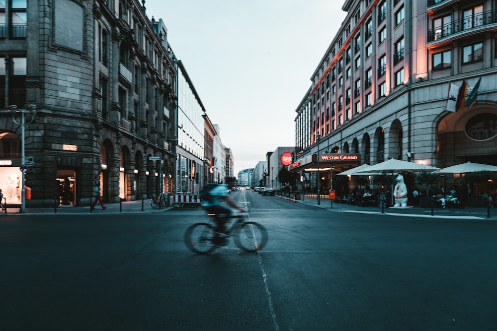 time lapse photo of person riding bike during daytime