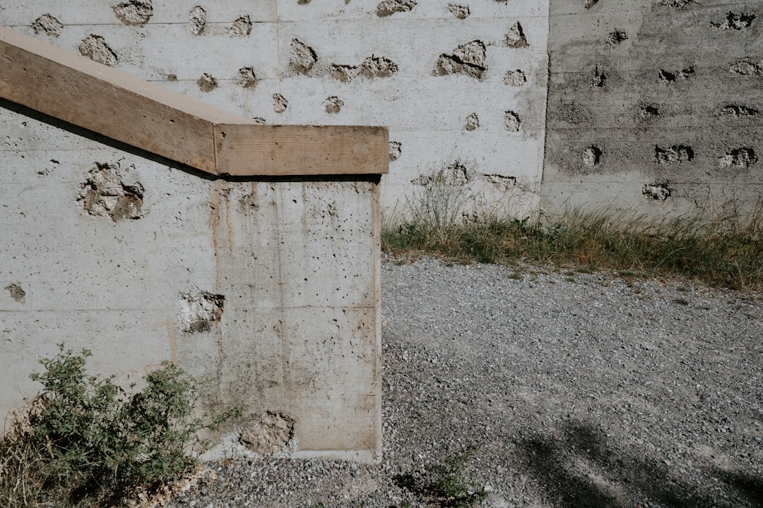 gray and brown concrete wall and stair with holes