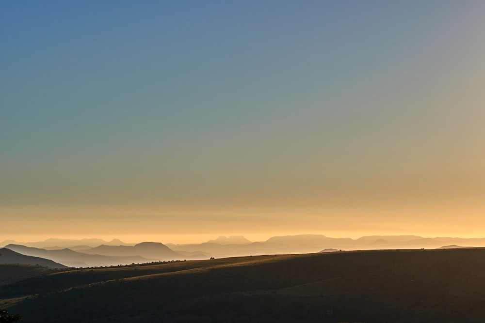 silhouette of hill during sunrise