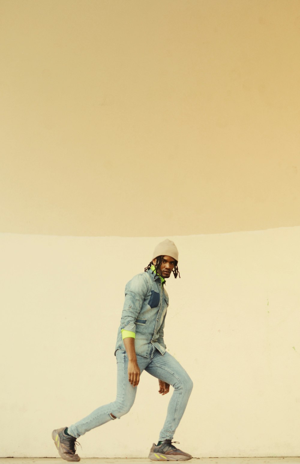 man in gray denim jacket and jeans