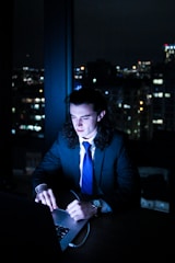 man in suit using laptop