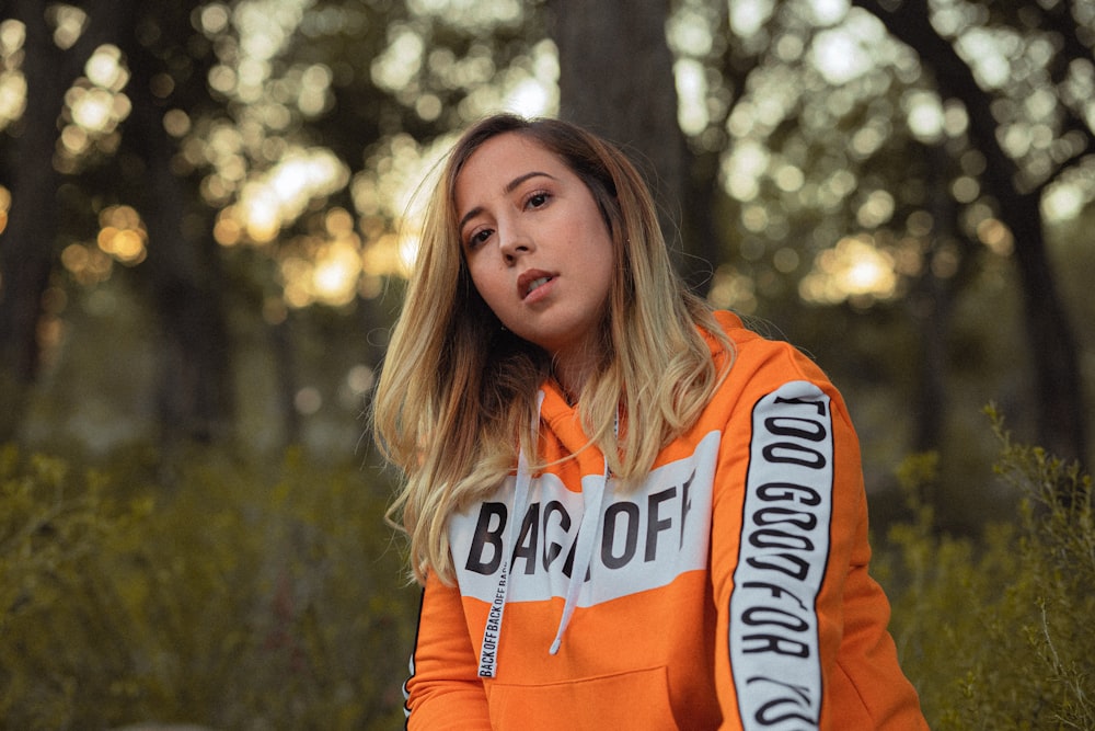 woman in orange hoodie