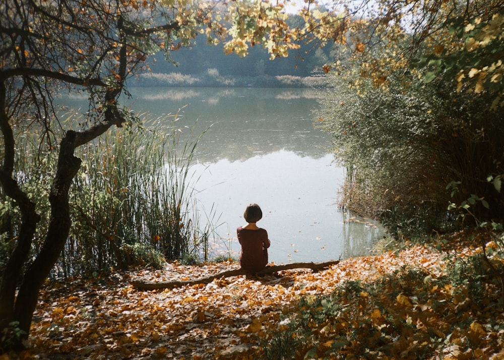 woman sitting near body of water