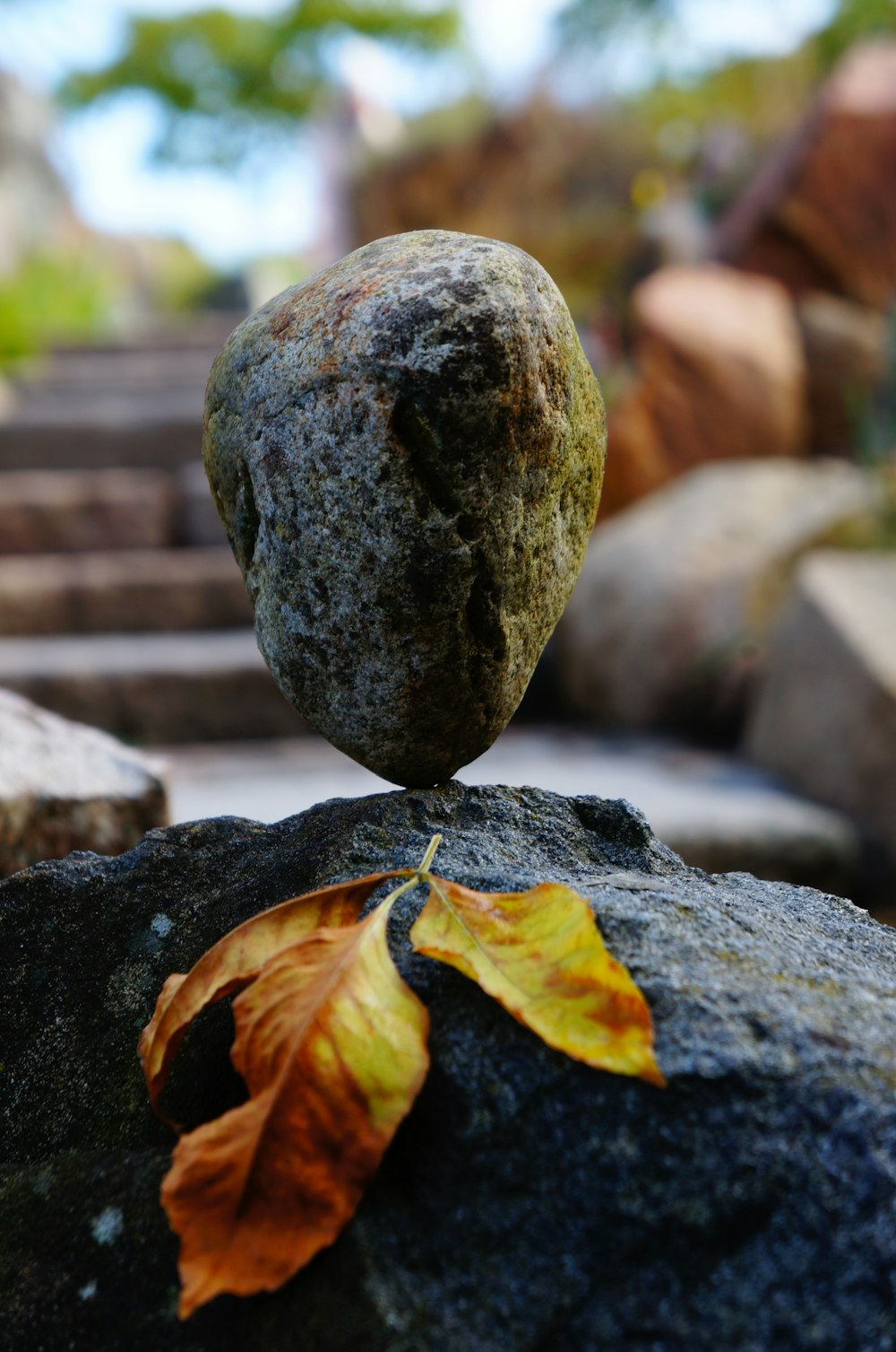 brown stone standing on stone with leaf