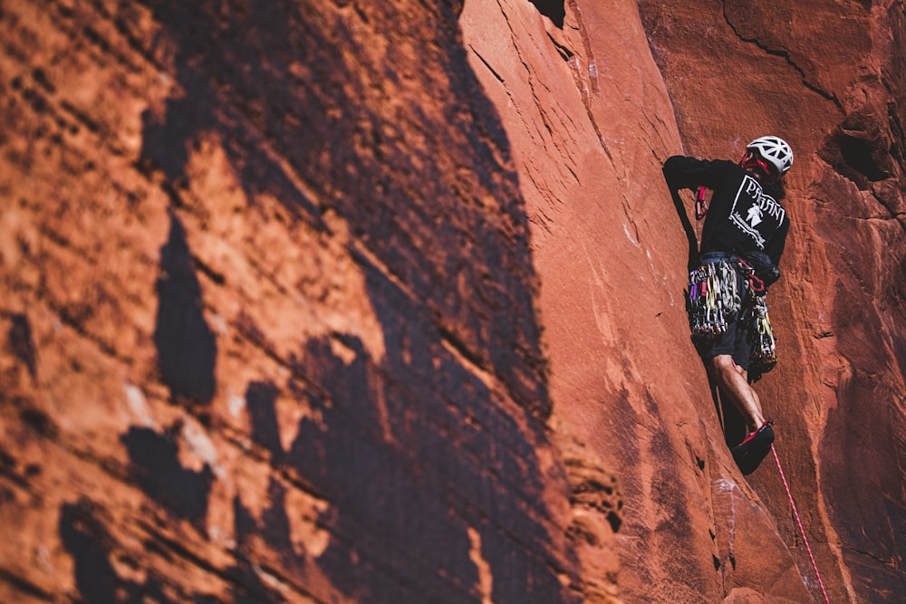 man climbing on rock