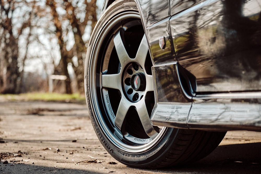 macro photography of chrome 6-spoke wheel and tire set