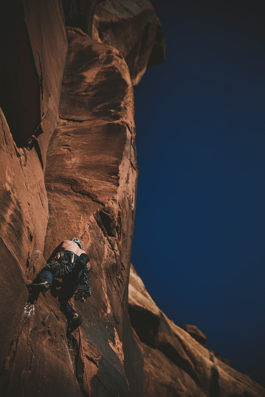 man climbing on cliff