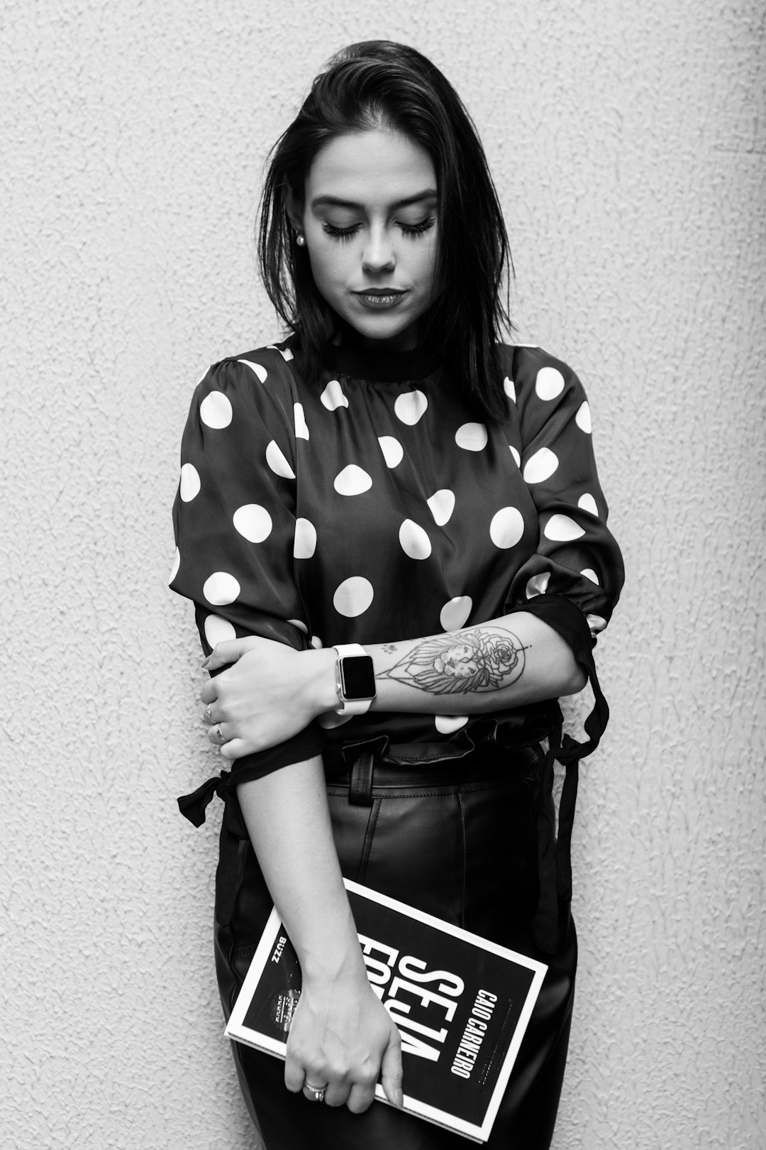 grayscale photo of woman in polka-dot quarter-sleeved shirt