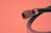 A close-up view of a coaxial cable connector with a metal tip and threaded base. The background is a solid color, adding emphasis to the cable's features and structure.