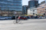 A cyclist in motion through city streets, sporting qam’s streamlined, functional apparel.