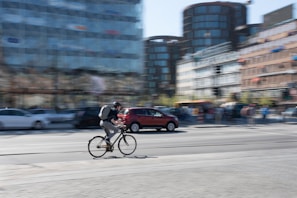 An action shot of a person cycling through the city wearing Lumina Apparel’s breathable and stylish activewear.