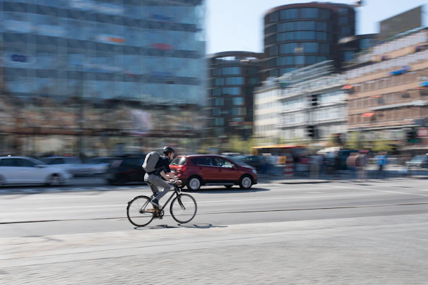 Lifestyle image of a person cycling through the city wearing accufinrtech gear.