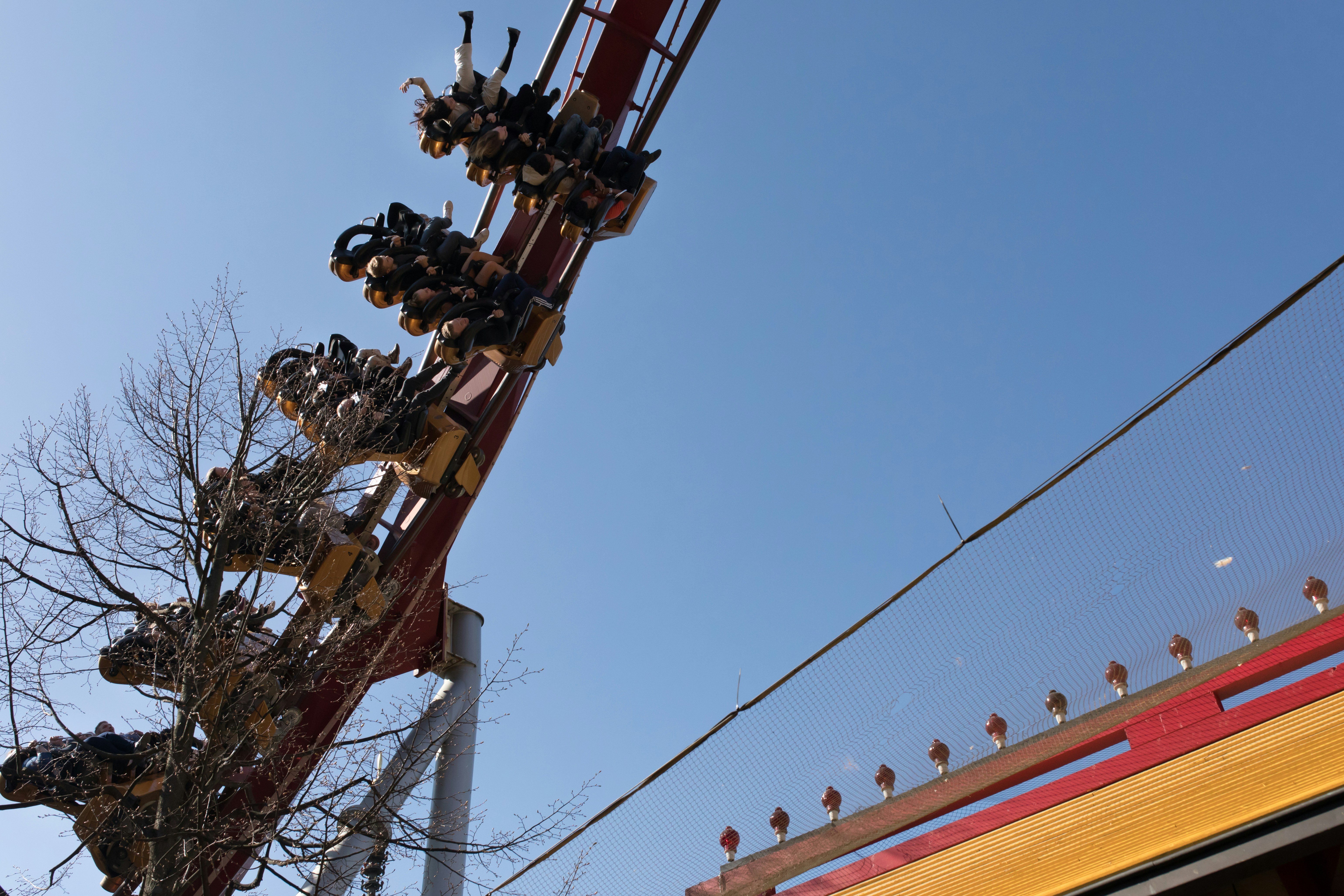 people riding roller coaster during daytime
