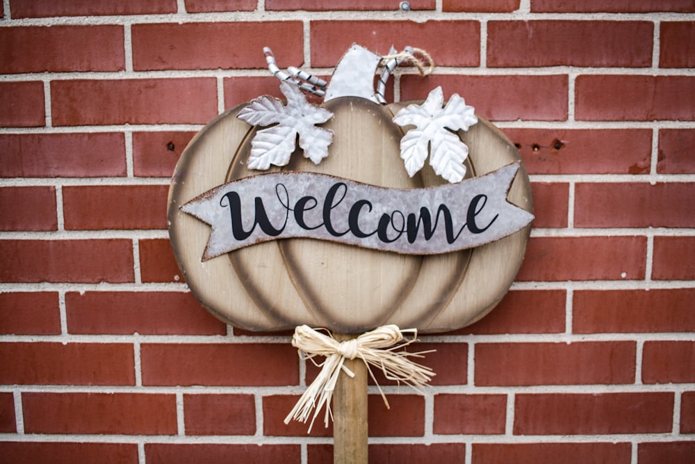 brown and gray pumpkin with welcome text sign