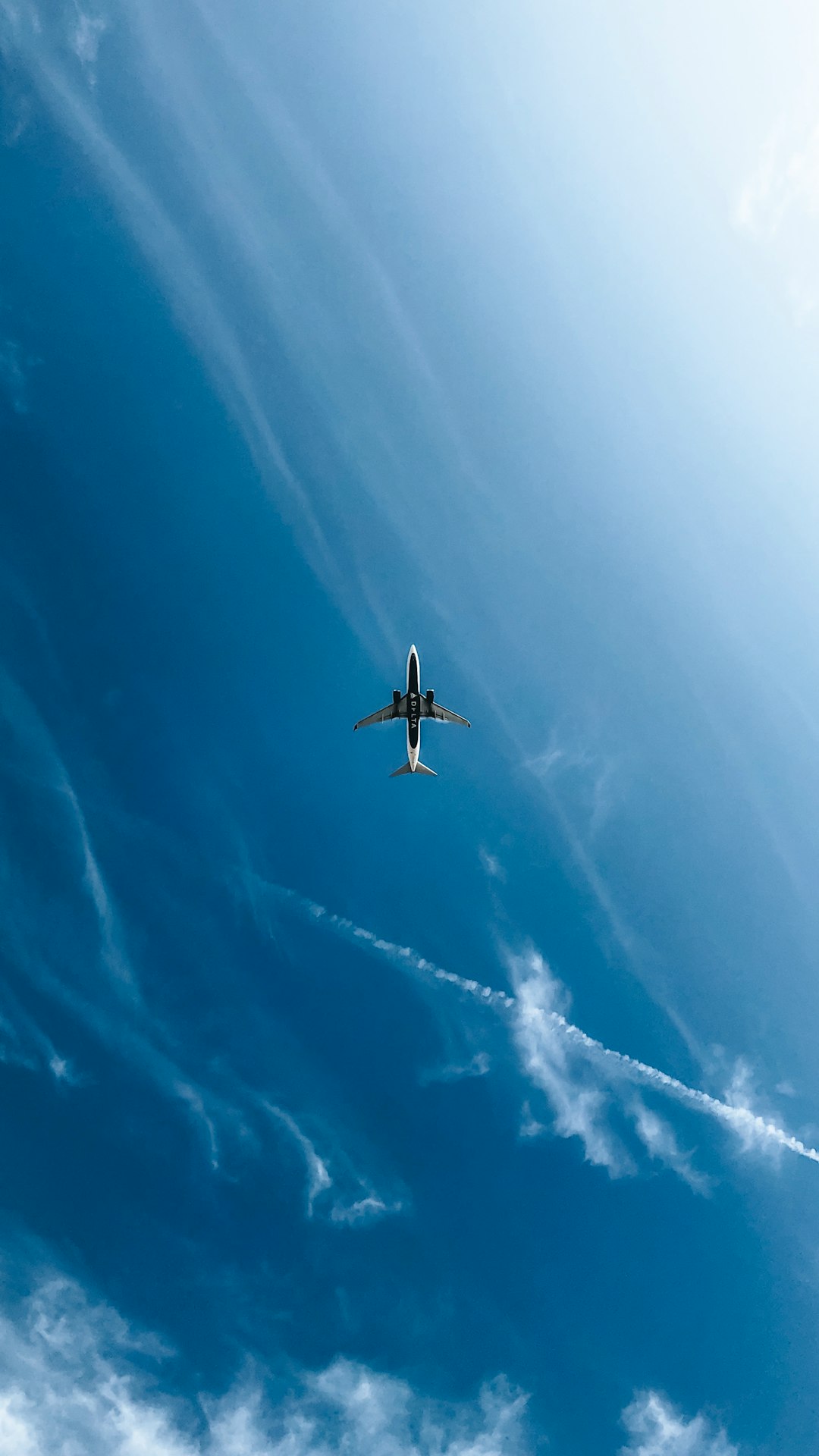 white and black airplane in the sky during daytime