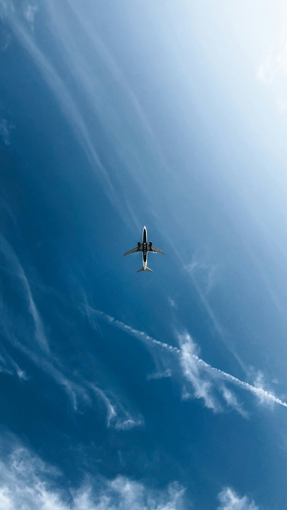 white and black airplane in the sky during daytime