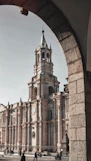 people walking beside gray concrete church