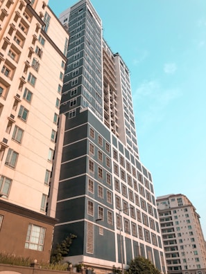 A towering modern building in Rawalpindi with navy blue and golden accents under a clear sky