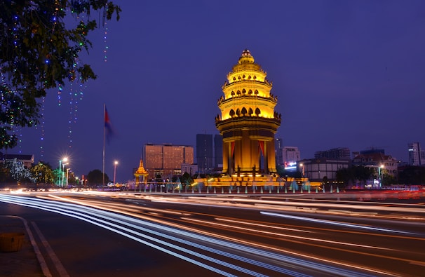 a clock tower lit up at night in a city