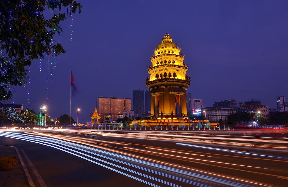 a clock tower lit up at night in a city