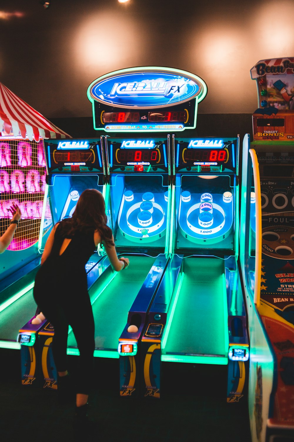 woman playing arcade game machine