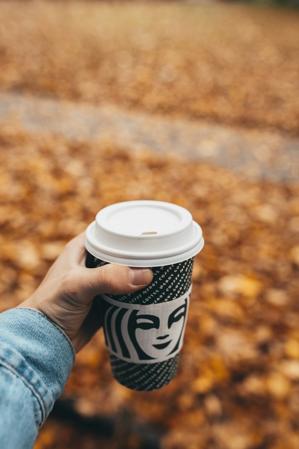 black and white Starbucks disposable cup with lid