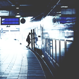 A serene shot of travelers boarding a sleek Shinkansen train at dawn.