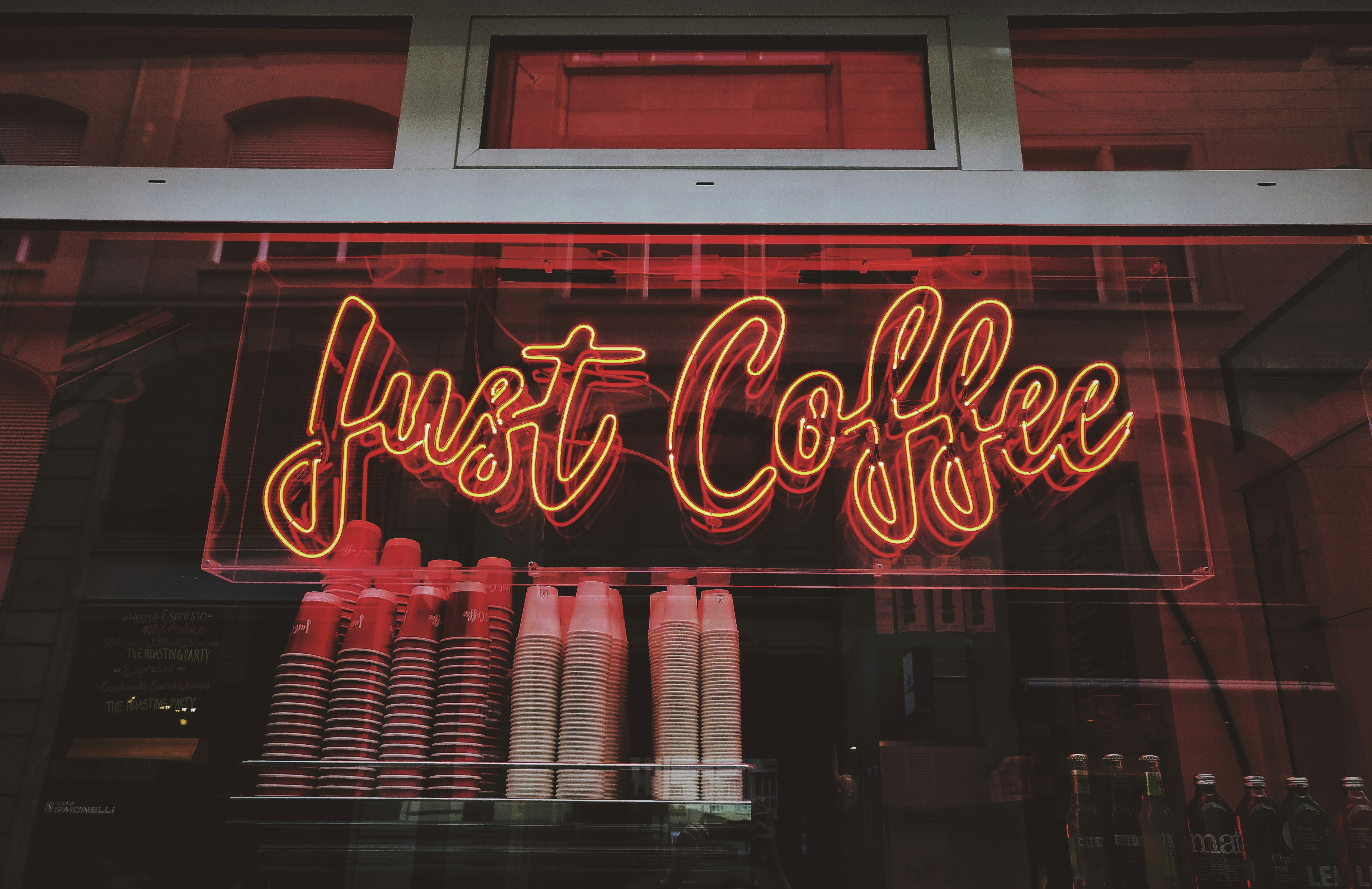 Just Coffee neon sign at night