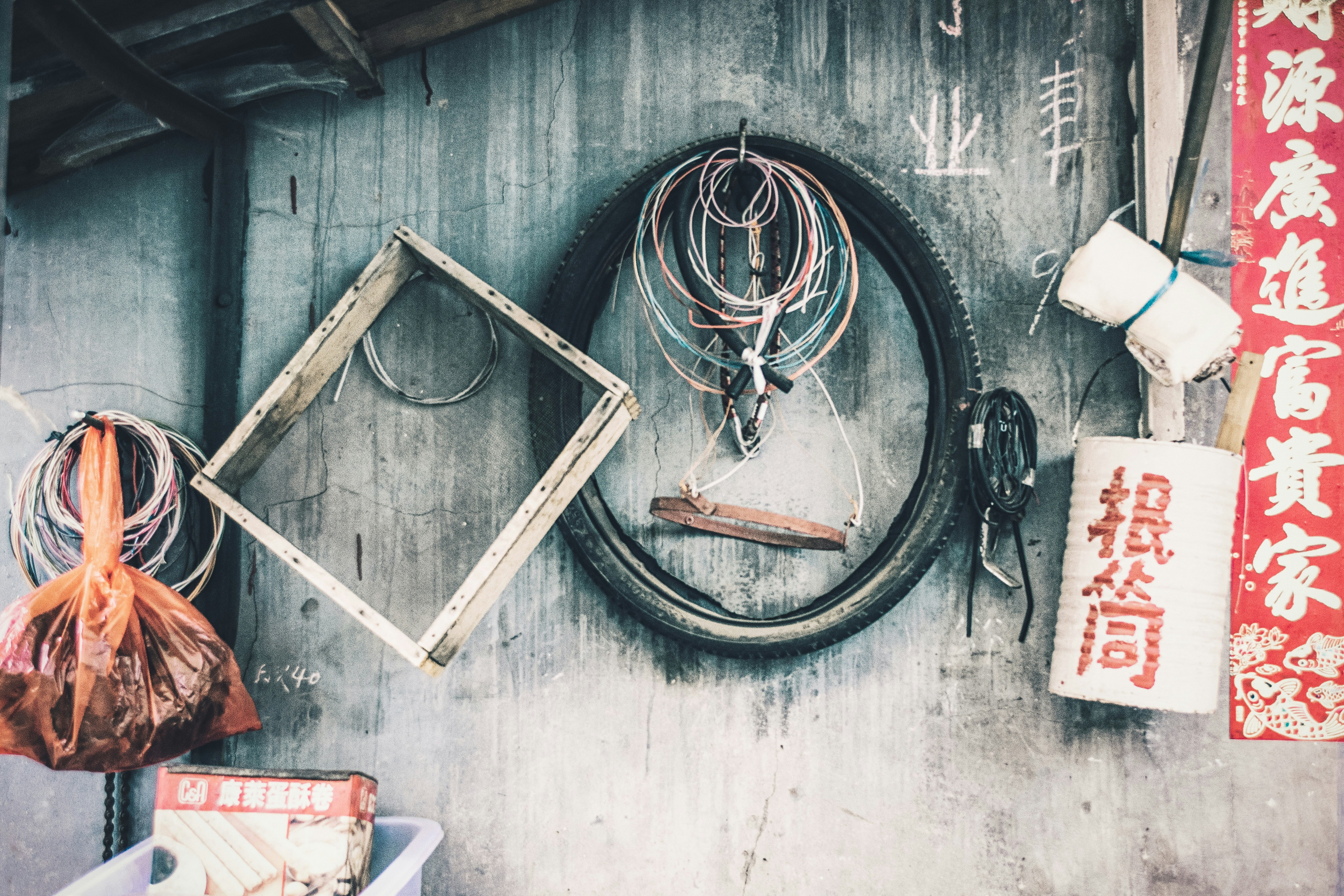 square gray wooden frame near bike tire and tin can decor